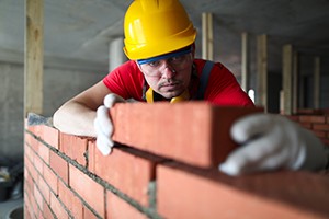 Worker placing bricks