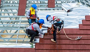 Workers roofing a building